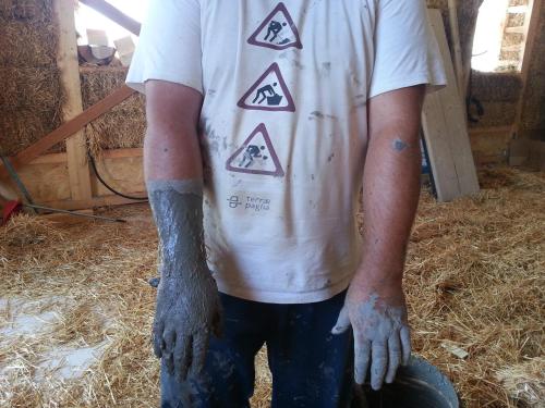 a man wearing a white shirt with tattoos on his arms at B&B EcoAntico casa in paglia in Maiolo