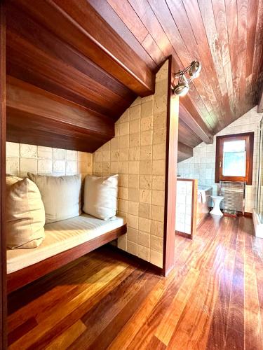 a bed in a room with a wooden ceiling at Torre de las Águilas, Bellver, Puigcerdá in Bellver de Cerdanya 