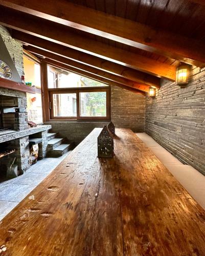 a large wooden table in the middle of a room at Torre de las Águilas, Bellver, Puigcerdá in Bellver de Cerdanya 