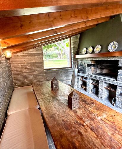 a large wooden table in a room with a window at Torre de las Águilas, Bellver, Puigcerdá in Bellver de Cerdanya 