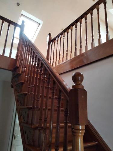 a person walking up the stairs in a house at Tranquil Carlow Bungalow in Crockaun