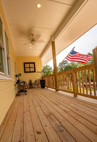 an empty porch with an american flag on it at Private Soundside Home In Emerald Isle in Emerald Isle