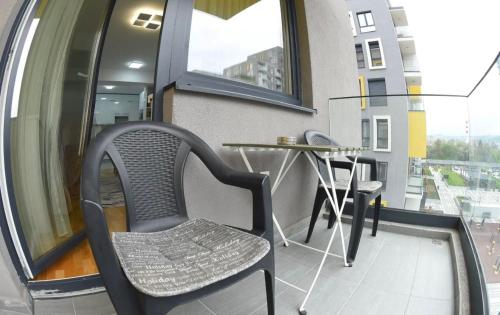 a table and chairs in a room with a window at 22 House in Skopje