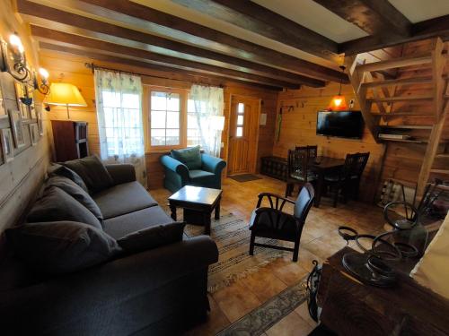 a living room with a couch and a table at Osada Magury - Bieszczady in Wetlina