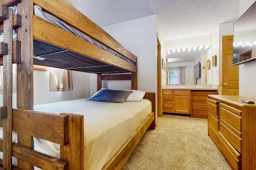a bedroom with a bunk bed and a bathroom at Snowdance Condo A101 in Keystone