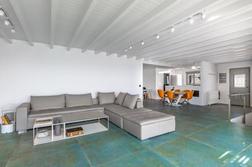 a living room with a couch and a table at Villa Kouneli - an exceptional holiday in Koundouros