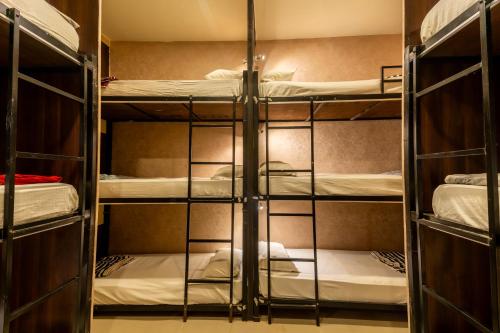 a room with four bunk beds in it at Social Safari Hostel, PARK STREET in Kolkata