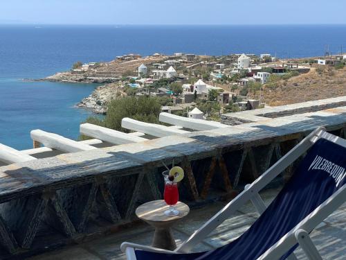 a pair of chairs and a table with a vase on it at Villa Kouneli - an exceptional holiday in Koundouros