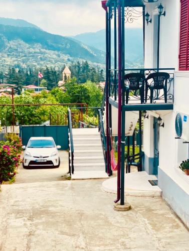 a car parked on the side of a house at House of Warmth in Bagdatʼi