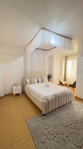 a large white bedroom with a large bed in it at Wander home 3bedroom in Kisumu