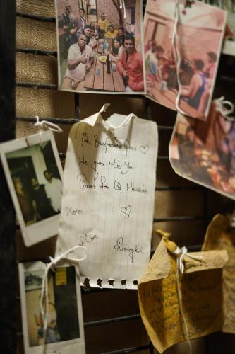 a pile of photos and a sheet of paper at Social Safari Hostel, PARK STREET in Kolkata