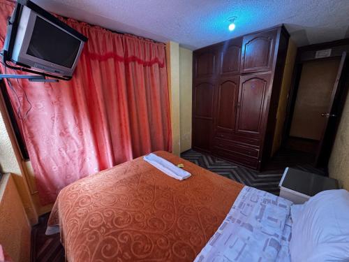 Ένα ή περισσότερα κρεβάτια σε δωμάτιο στο Hotel Jimmy Latacunga