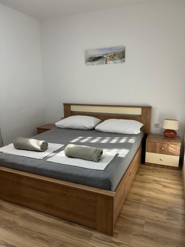 a bedroom with a bed with two pillows on it at Apartmani Predovan in Vrsi