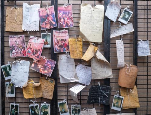 a wall with many photos and tags on it at Social Safari Hostel, PARK STREET in Kolkata