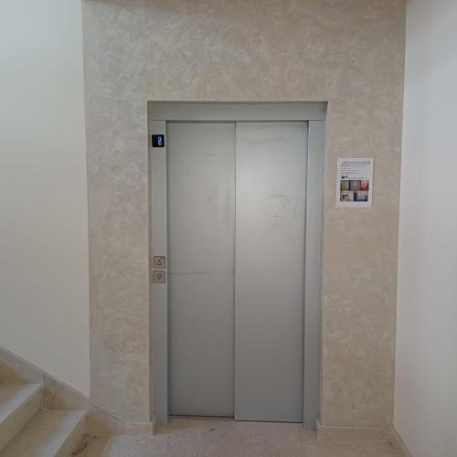 a white elevator in a room with stairs at Wellness & Spa Red Paradise in Donje Mladice