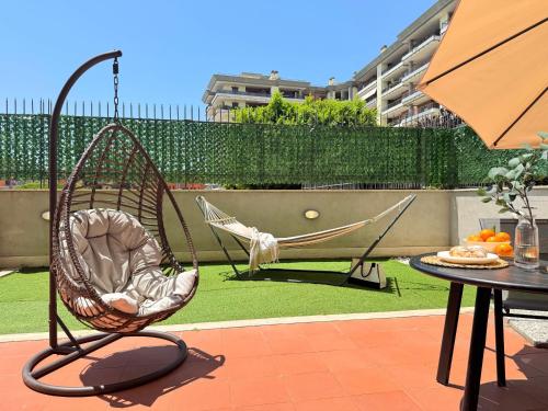 a hammock and a chair on a patio at Sun Nest Apartment - terrace & garage in Fiumicino