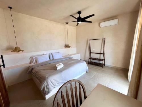 a bedroom with a bed and a ceiling fan at La Ventana Hostel in La Ventana