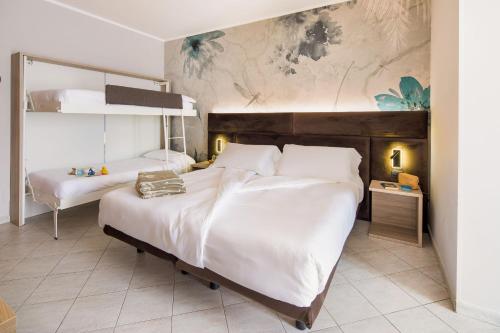 Postel nebo postele na pokoji v ubytování Hotel Gabriella