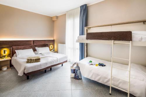 Postel nebo postele na pokoji v ubytování Hotel Gabriella