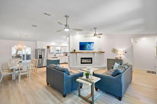 a living room with two blue couches and a dining room at 3BR Family Getaway Steps to Sand & Sun in Saint Augustine