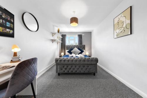 a bedroom with a chair and a mirror at South Stays in London