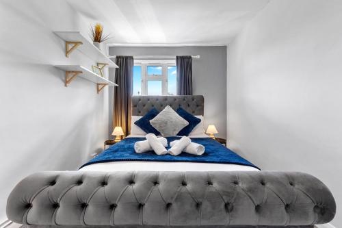 a bedroom with a large bed with two towels at South Stays in London