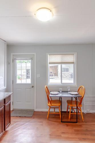 a dining room with a table and two chairs at Westlake Cherry Valley Cottage in Wellington