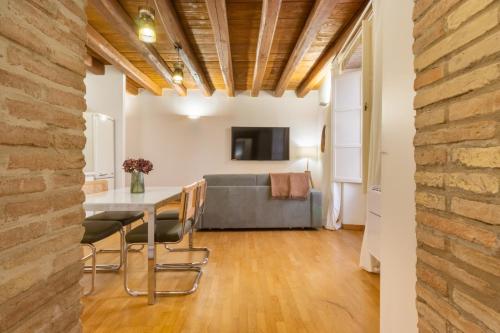 a living room with a table and a couch at Martini Castello Boutique Apartments - Historic Center & Lift in Cagliari