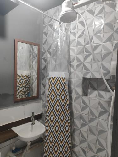 a bathroom with a shower and a sink and a mirror at Loftjesus in Campina Grande