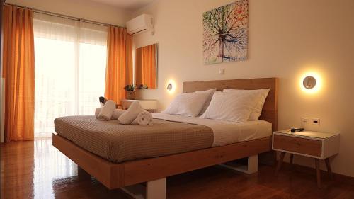 a bedroom with a large bed with a large window at villa strati in Nafplio