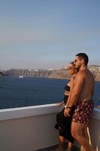 two men standing on the edge of a cruise ship at The Noverian Bios Caldera Sunset Suites in Akrotiri