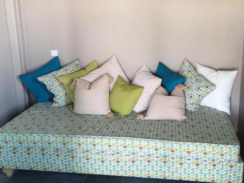 a bunch of pillows sitting on a bed at The Iconpainter Kalamaki Villa in Kómboi
