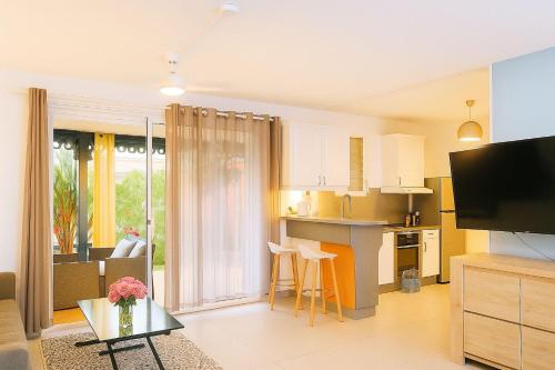 a room with a kitchen and a living room at Studio COEUR DE VILLAGE - ORIENT BAY in Orient Bay