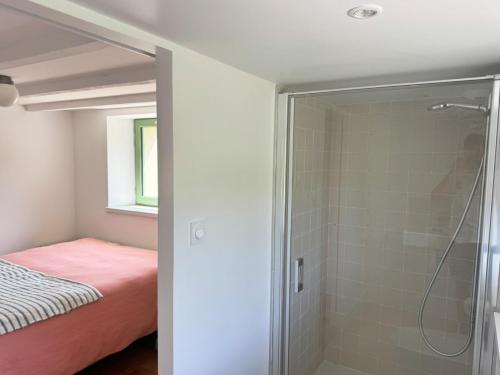 a bathroom with a shower and a bed in a room at Villa Les Embruns sea view Beg Ar Fry 10 people in Guimaëc