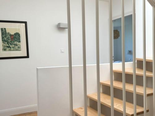 a room with white walls and wooden shelves at Villa Les Embruns sea view Beg Ar Fry 10 people in Guimaëc