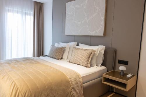 a bedroom with a large bed with white pillows at Hotel Medistone in Omiš
