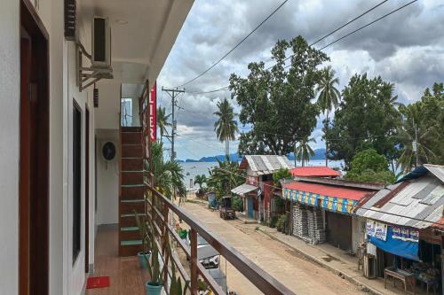 a balcony of a building with a view of a street at Kamalay Pension House in Nagpoyopoyo Island