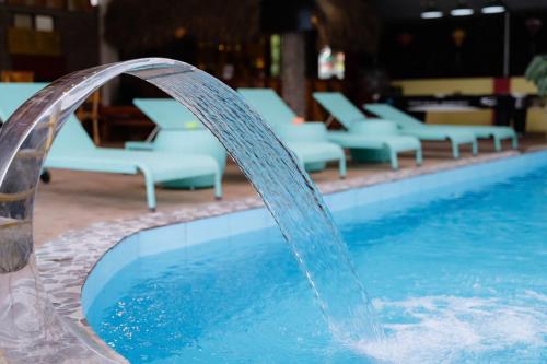 a water fountain in front of a swimming pool at Ha Giang Loop Rabbit Hostel & Tours in Ha Giang
