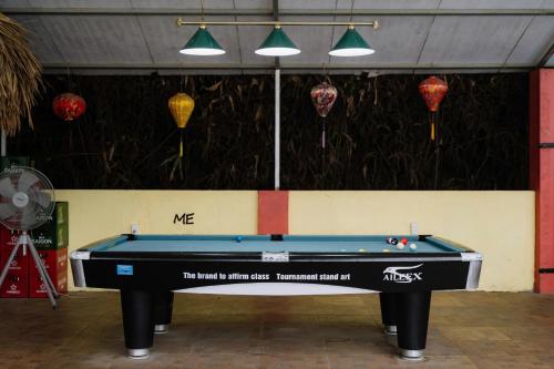 a pool table in a room with ping pong balls at Ha Giang Loop Rabbit Hostel & Tours in Ha Giang