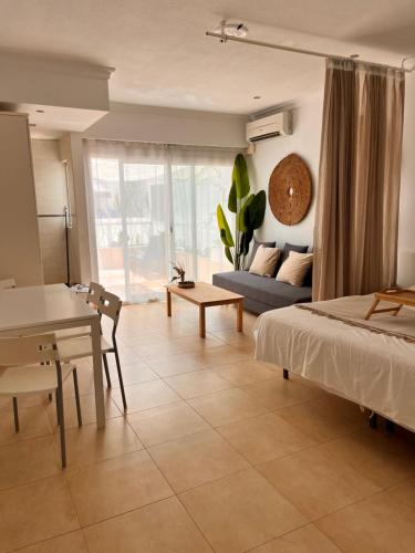 a bedroom with a bed and a table and a couch at Hotel Pyr private studio in Fuengirola
