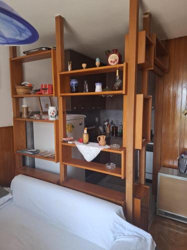 a room with a book shelf with various items on it at Anako in Novi Vinodolski