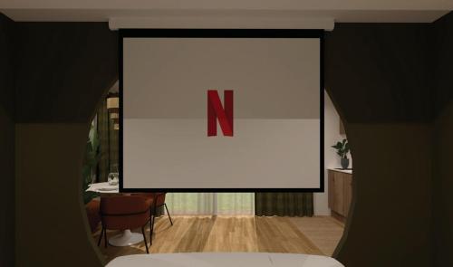 a large screen with the letter n on it in a room at Escape - Suite with Balneo and Sauna - Downtown in Pontarlier
