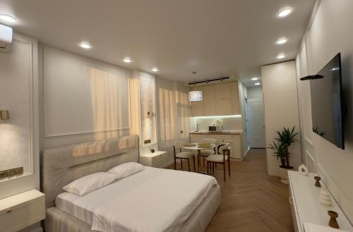 a small bedroom with a bed and a kitchen at NBG d 'amore Appart in Batumi