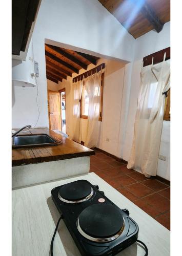 a kitchen with a black pot on the floor at Serena Cumbre Lodge in San Rafael