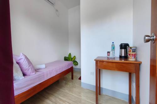 a room with a couch and a table at Kamalay Pension House in Nagpoyopoyo Island