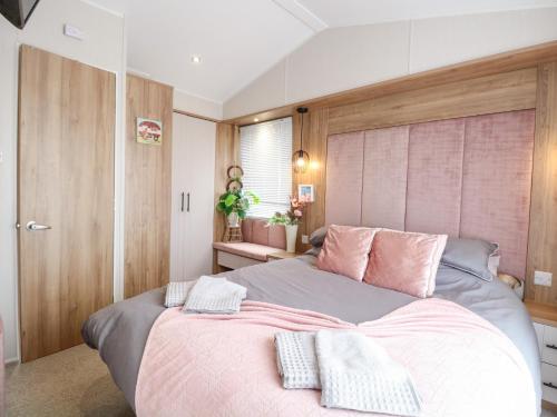 a bedroom with a large bed with two pillows on it at No 2 - Seaview in Lowestoft