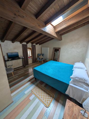 a bedroom with a large bed and a wooden ceiling at Casale Elisa Country Hotel in Ladispoli