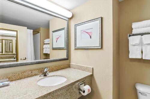 a bathroom with a sink and a mirror at Country Inn & Suites by Radisson, Princeton, WV in Princeton