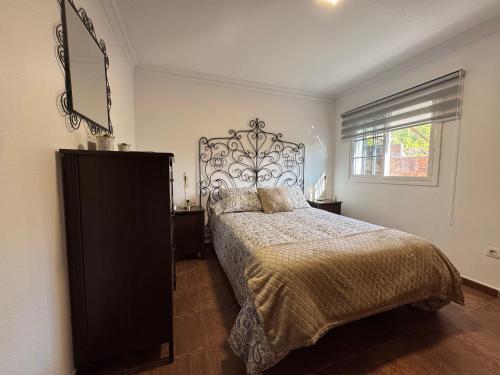 a bedroom with a large bed and a window at La Planta Vieja III in La Orotava