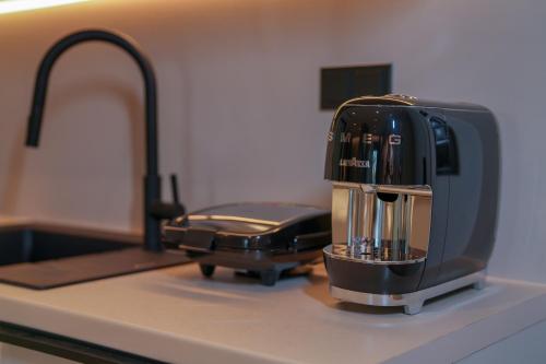 a coffee maker sitting on a counter next to a sink at Sunrise Luxury Apartments in Fanárion